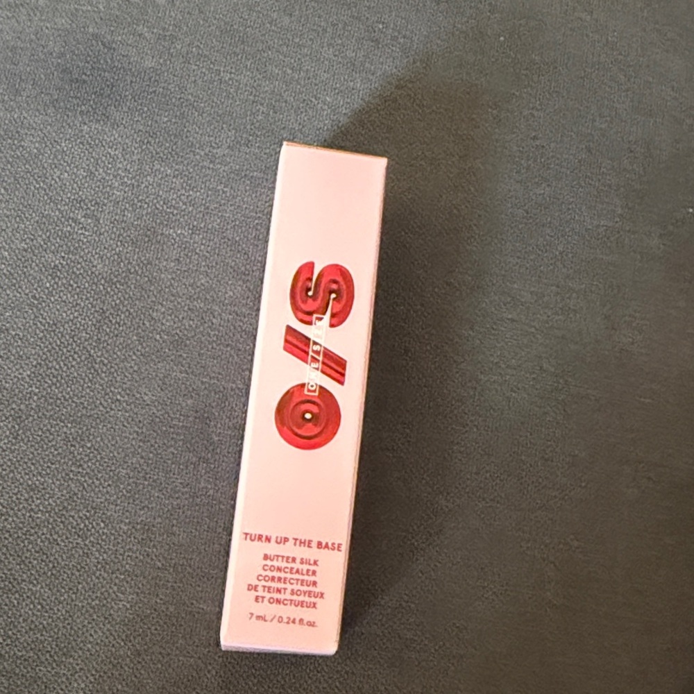 One Size turn up the base Butter Silk Concealer. Shade medium dark 3